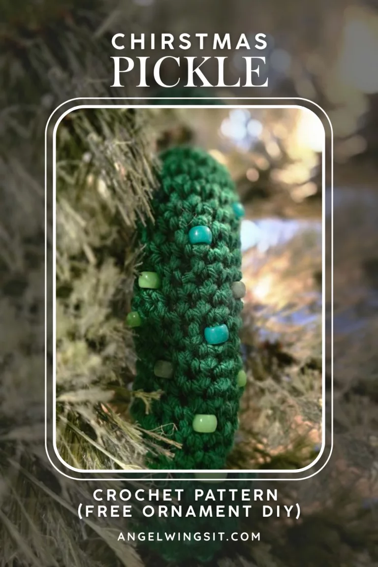 Handmade crochet Christmas pickle ornament with green beads, hanging on a tree branch. Promotes a free DIY crochet pattern from angelwingsit.com.