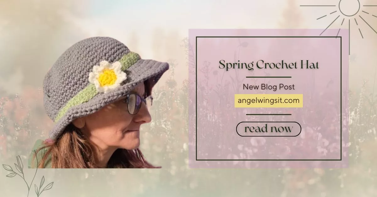 A person wearing a gray crochet spring hat with a green band and a white and yellow daisy embellishment, standing in front of a soft, pastel floral background. Text on the right reads “Spring Crochet Hat – New Blog Post – angelwingsit.com – read now.”