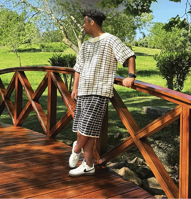 Man in crochet shirt and shorts