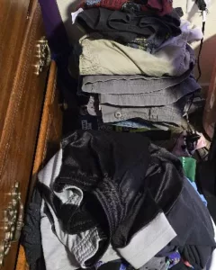 Sorting clean laundry into designated baskets instead of folding, an example of low energy cleaning tips for chronic illness.